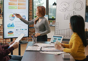 Business people looking at briefing presentation on display, analyzing charts information and statistics to plan financial growth and development. Colleagues brainstorming strategy ideas